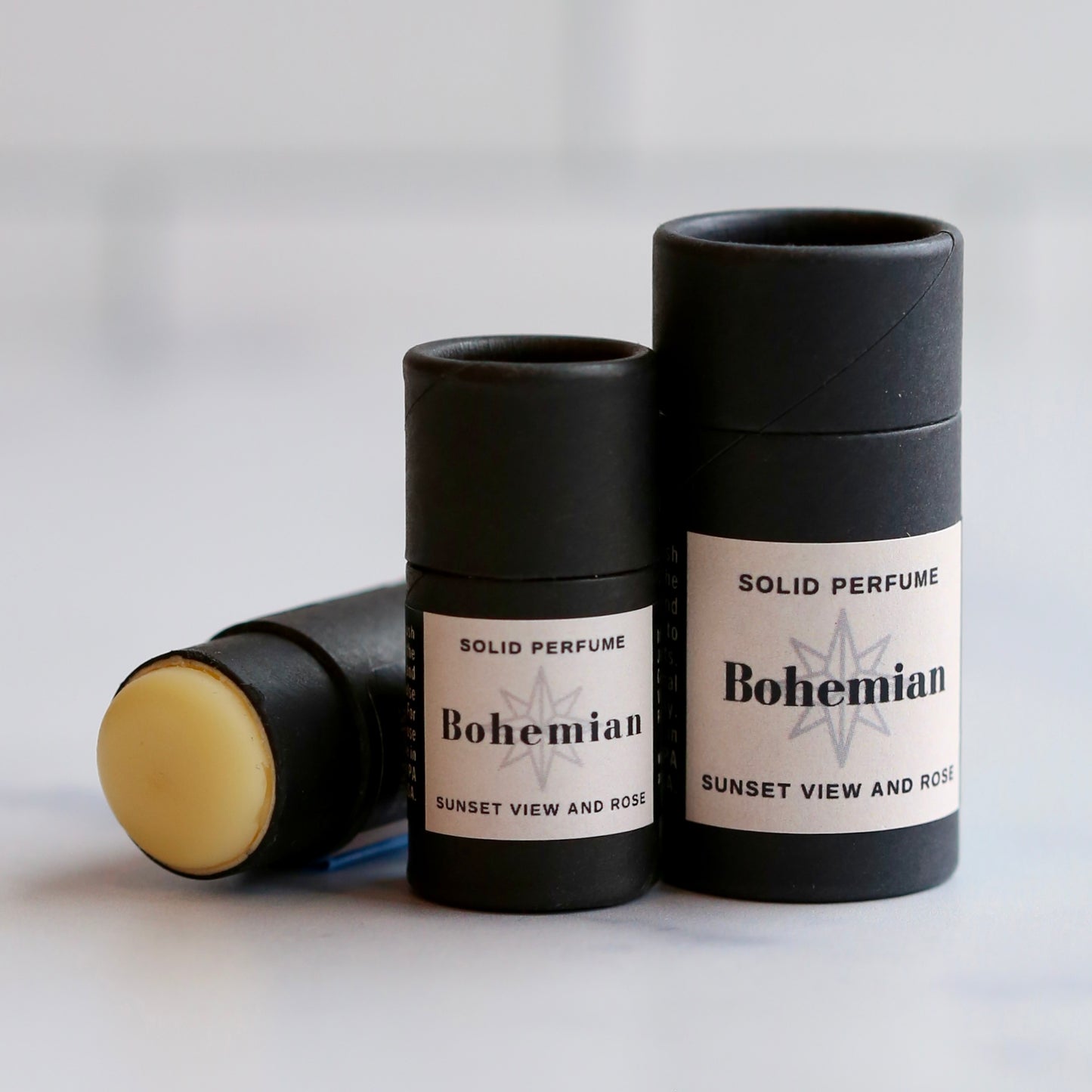 Three solid perfume sticks labeled 'Bohemian' on a light background