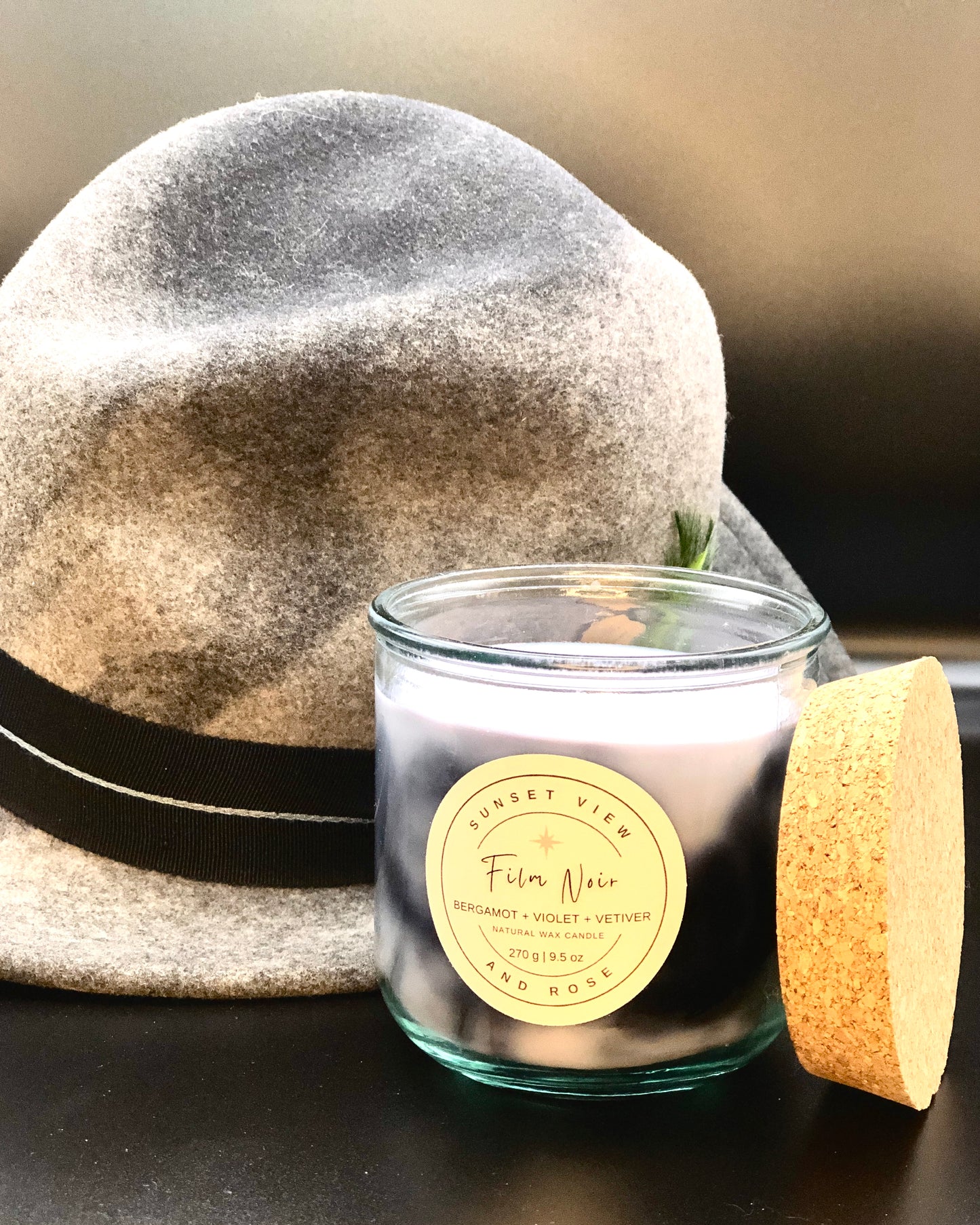 Sunset View and Rose - Film Noir scented candle with notes of Bergamot, Violet and Vetiver. Sunset View and Rose makes ecofriendly candles with ethically sourced waxes, nontoxic fragrances, and recycled materials. Our candles and home fragrances are sustainably made with love in Pittsburgh, Pennsylvania.